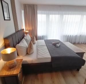 a bedroom with a large bed and a large window at SKY INN - nahe Messe contactless check in in Hannover