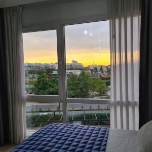 a bedroom with a window with a view of a city at Bahía Grande Nordelta con Cochera in Benavídez