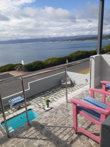 a balcony with a view of the water at 65onCliff in Gansbaai
