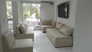sala de estar con sofá y 2 sillas en Amplio departamento Balcon pleno centro Peatonal en Mendoza