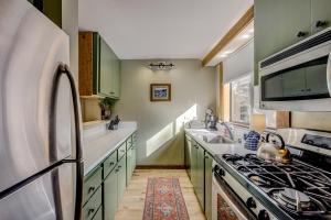 a kitchen with green cabinets and a stove top oven at Enjoyable Northstar Condo in Kingswood Estates