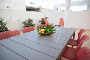 a dining room table with a bowl of fruit on it at VILLA PONENTE - Beach & Jacuzzi in Torre Santa Sabina
