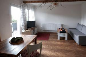 a living room with a table and a couch at Chalupa Cácorka in Přední Výtoň