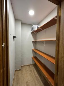 a walk in closet with wooden shelves at Apartamentos adrian in Jerez de la Frontera