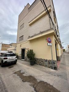 a car parked in front of a building at Apartamentos adrian in Jerez de la Frontera