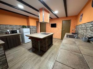 a kitchen with an island in the middle of a room at Apartamentos adrian in Jerez de la Frontera