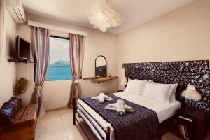 a bedroom with a bed with two stuffed animals on it at Sagini Hotel in Loutra Edipsou