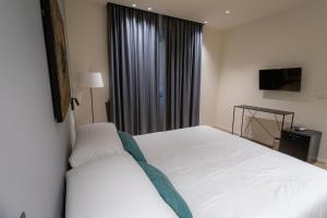 A bed or beds in a room at Pasubio Quattro BB