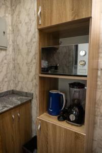 a wooden cabinet with a blender in a kitchen at Awesome 1-Bed-Apt With 24hrs Power & Fast WiFi in Lagos