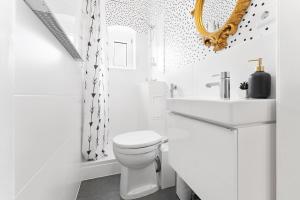 a white bathroom with a toilet and a sink at Neues modernes Apartment am Theater-zentral mit Privatparkplatz in Cottbus