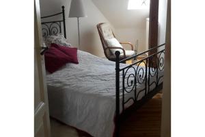 a bedroom with a bed and a chair at Private Room in Hannover