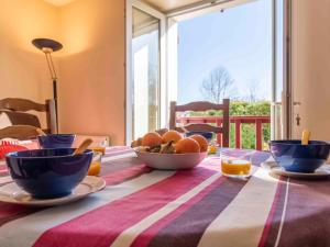 a table with bowls of fruit on top of it at Apartment Kafartenea by Interhome in Urrugne