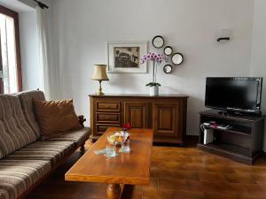 a living room with a couch and a coffee table at Apartment Vela da Reto by Interhome in Muralto