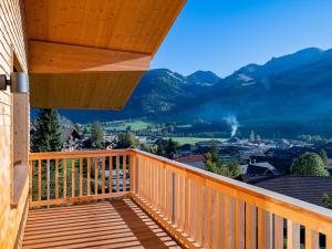 a wooden balcony with a view of the mountains at Apartment Sparenmoos - OB - DG Süd-West by Interhome in Zweisimmen