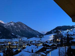 a town covered in snow with mountains in the background at Apartment Sparenmoos - OB - DG Süd-West by Interhome in Zweisimmen