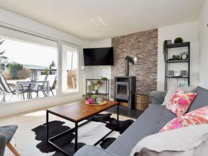 a living room with a couch and a table at Holiday Home Anna by Interhome in Heidersbach