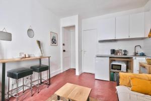 a kitchen and living room with a couch and a table at Magnifique Studio, Place de la Bastille in Paris