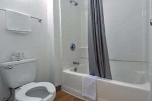 a white bathroom with a toilet and a shower at Motel 6-Chino, CA - Los Angeles Area in Chino