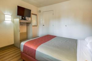 a small room with a bed and a television at Motel 6-Chino, CA - Los Angeles Area in Chino