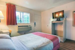 a hotel room with a bed and a television at Motel 6-Chino, CA - Los Angeles Area in Chino
