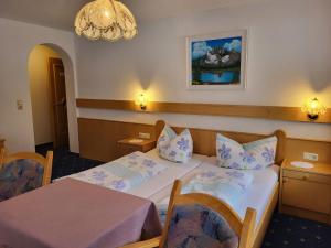 a hotel room with two beds and a chandelier at Apartment LaFontana by Interhome in Kappl