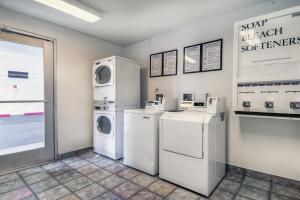 a laundry room with white appliances and a window at Motel 6-Chino, CA - Los Angeles Area in Chino