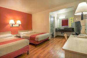 a hotel room with two beds and a television at Motel 6-Chino, CA - Los Angeles Area in Chino