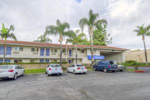 a group of cars parked in front of a building at Motel 6-Chino, CA - Los Angeles Area in Chino
