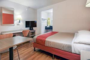 a hotel room with a bed and a desk and a bed sidx sidx sidx sidx at Motel 6-Chino, CA - Los Angeles Area in Chino