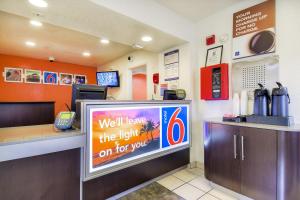 a fast food restaurant with a sign on a tv at Motel 6-Chino, CA - Los Angeles Area in Chino