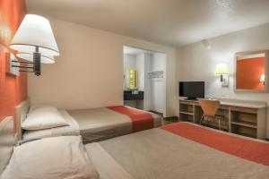 a hotel room with two beds and a desk at Motel 6-Chino, CA - Los Angeles Area in Chino