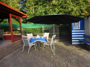 a table and chairs under an umbrella on a patio at Apartment Bismarcksberg by Interhome in Alt Schönau