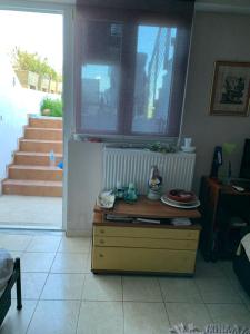 a room with a table and a window and a door at Holidays Pelion studio in Nea Anchialos