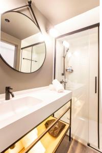 a bathroom with a sink and a mirror at Expo Hotel Barcelona in Barcelona