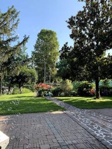 a brick path in a park with trees and grass at casa nonna Rica 