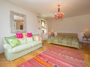 a living room with a couch and a bed and a mirror at Holiday Home Karin by Interhome in Zell am See