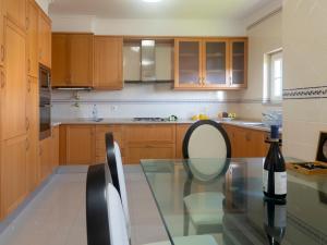 a kitchen with a glass table and a bottle of wine at Holiday Home Girassol by Interhome in Cascais
