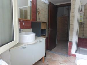 a bathroom with a white sink and a mirror at Casa Margherita in Nebida