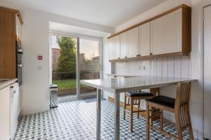 a kitchen with a table and chairs and a window at Hill Street Haven in Inverness