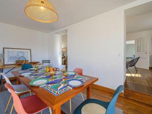 a dining room with a table and chairs at Holiday Home Glann Aven by Interhome in Le Bono