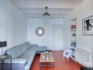 a living room with a couch and a table at Apartment la Rainette by Interhome in La Madrague