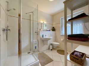 a bathroom with a shower and a toilet and a sink at Holiday Home Konrad by Interhome in Heidersbach