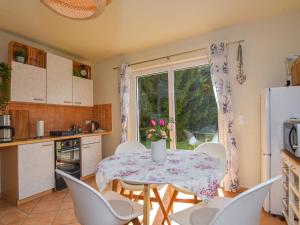 a kitchen and dining room with a table and chairs at Holiday Home Konrad by Interhome in Heidersbach