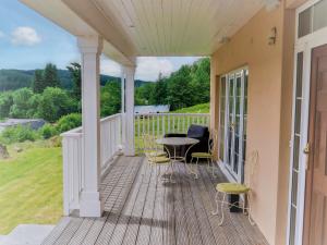 a porch with a table and chairs on it at Holiday Home Bearnock House by Interhome in Drumnadrochit