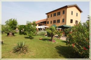 a large building in a yard with trees and plants at Country House Country Club in Noghera