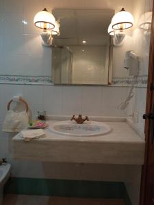 a bathroom with a sink and a mirror at apartamentos en Castellote el batan in Castellote +17 photos