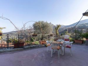 a table and chairs on a patio with a view at Holiday Home Lory House by Interhome in Villa Viani