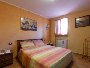 a bedroom with a large bed and a window at Holiday Home Lory House by Interhome in Villa Viani
