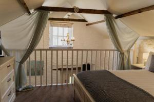 a bedroom with a bed and a window at Little England Retreats - Cottage, Yurt and Shepherd Huts in Othery