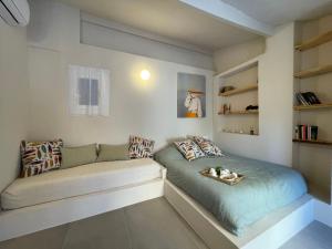 a room with a bed and a couch at Apartment La casa di Manu by Interhome in Porto Maurizio